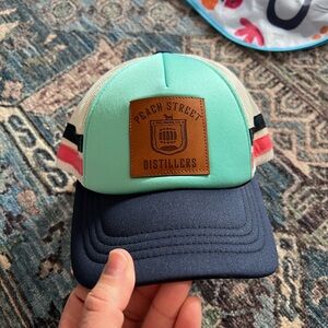 Peach Street Distillers Mint & Navy Trucker Hat from Palisades, Colorado